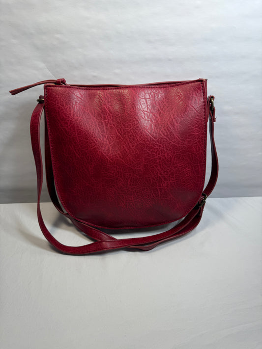 Crossbody Red Faux leather bag w/adjustable strap and side pocket.
