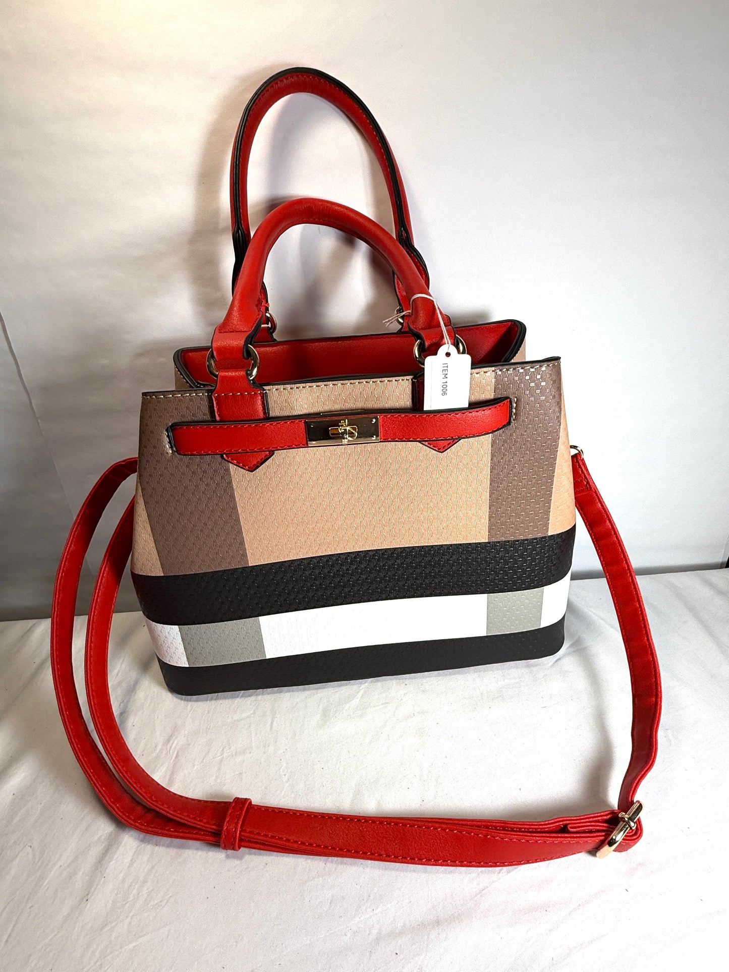 Plaid tote handbag with adjustable strap.
