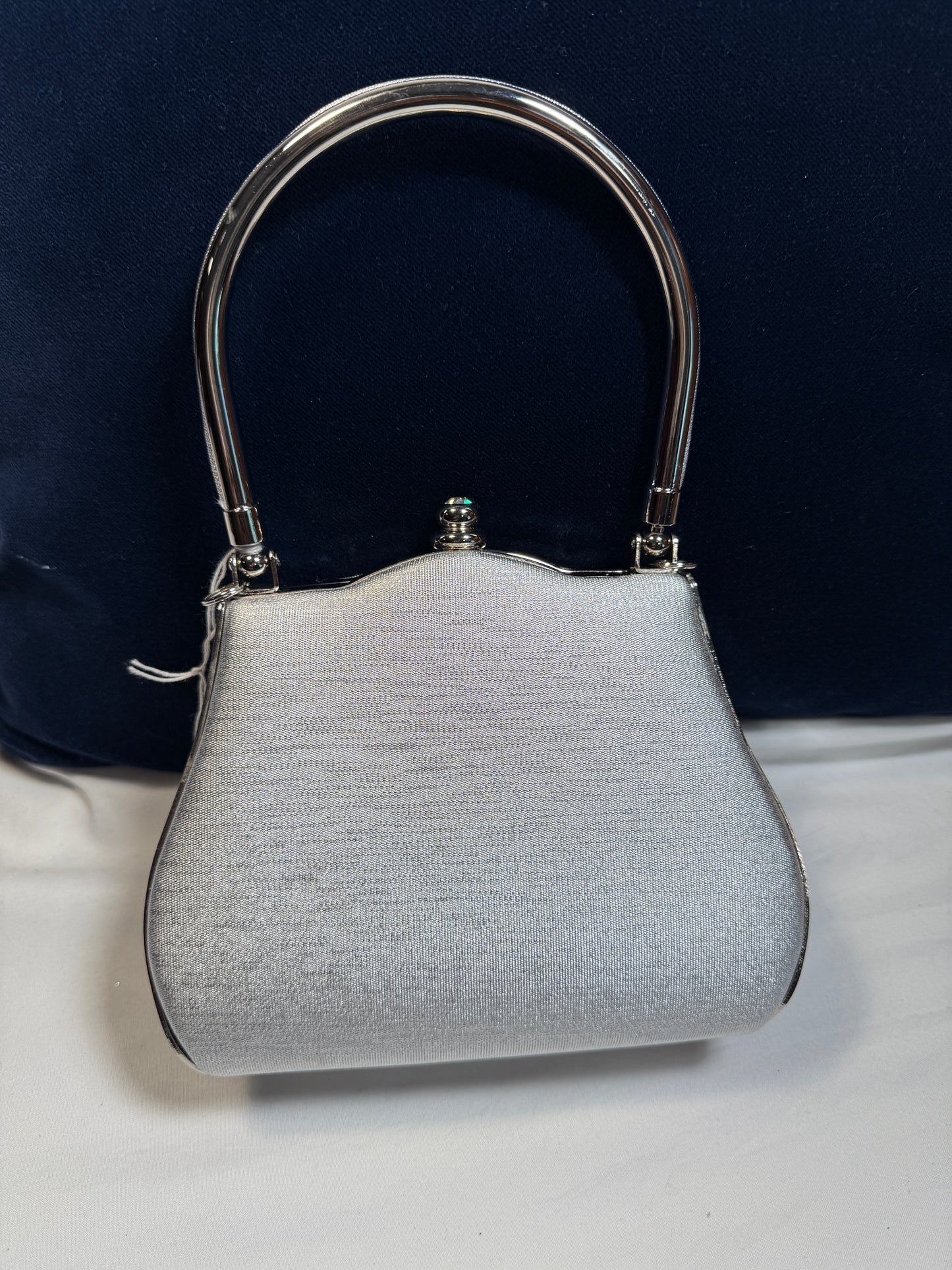 Small Evening Purse w/Clasp. Silver Fabric with Silvertone Metal Handle.