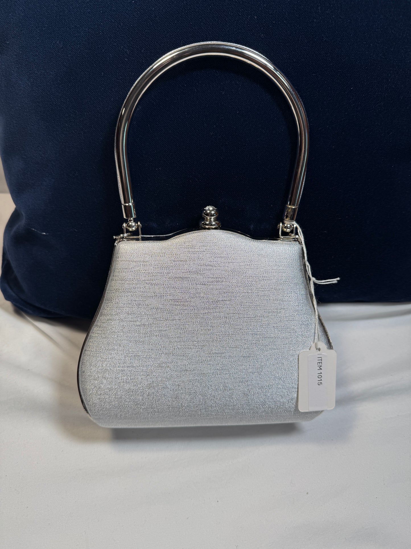 Small Evening Purse w/Clasp. Silver Fabric with Silvertone Metal Handle.