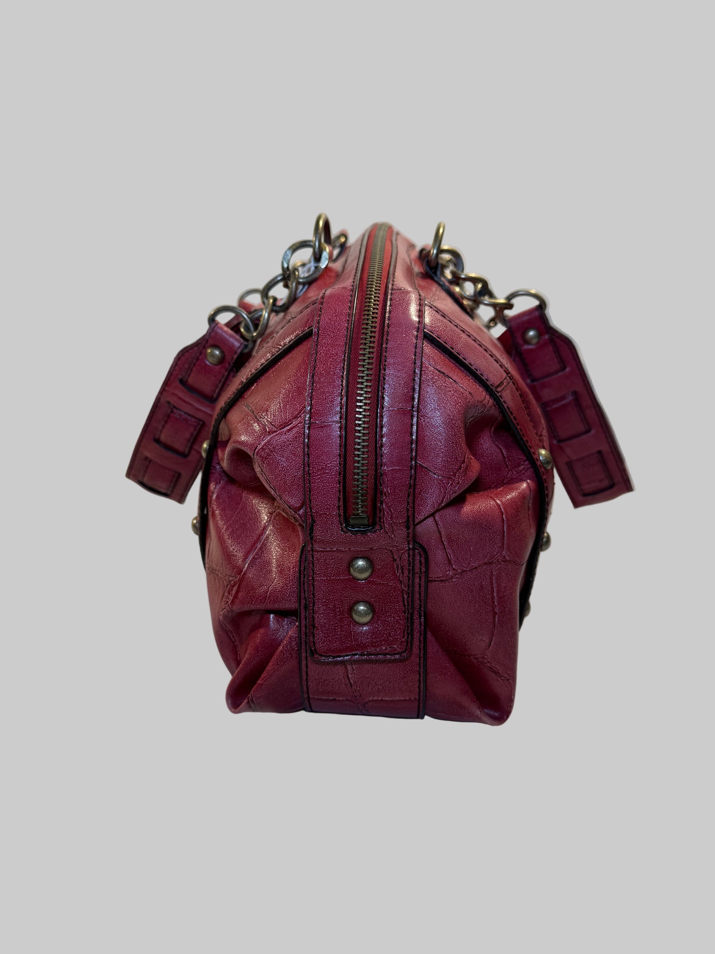 Pre-owned. Good condition. Burgundy duffle bag w/chain link straps