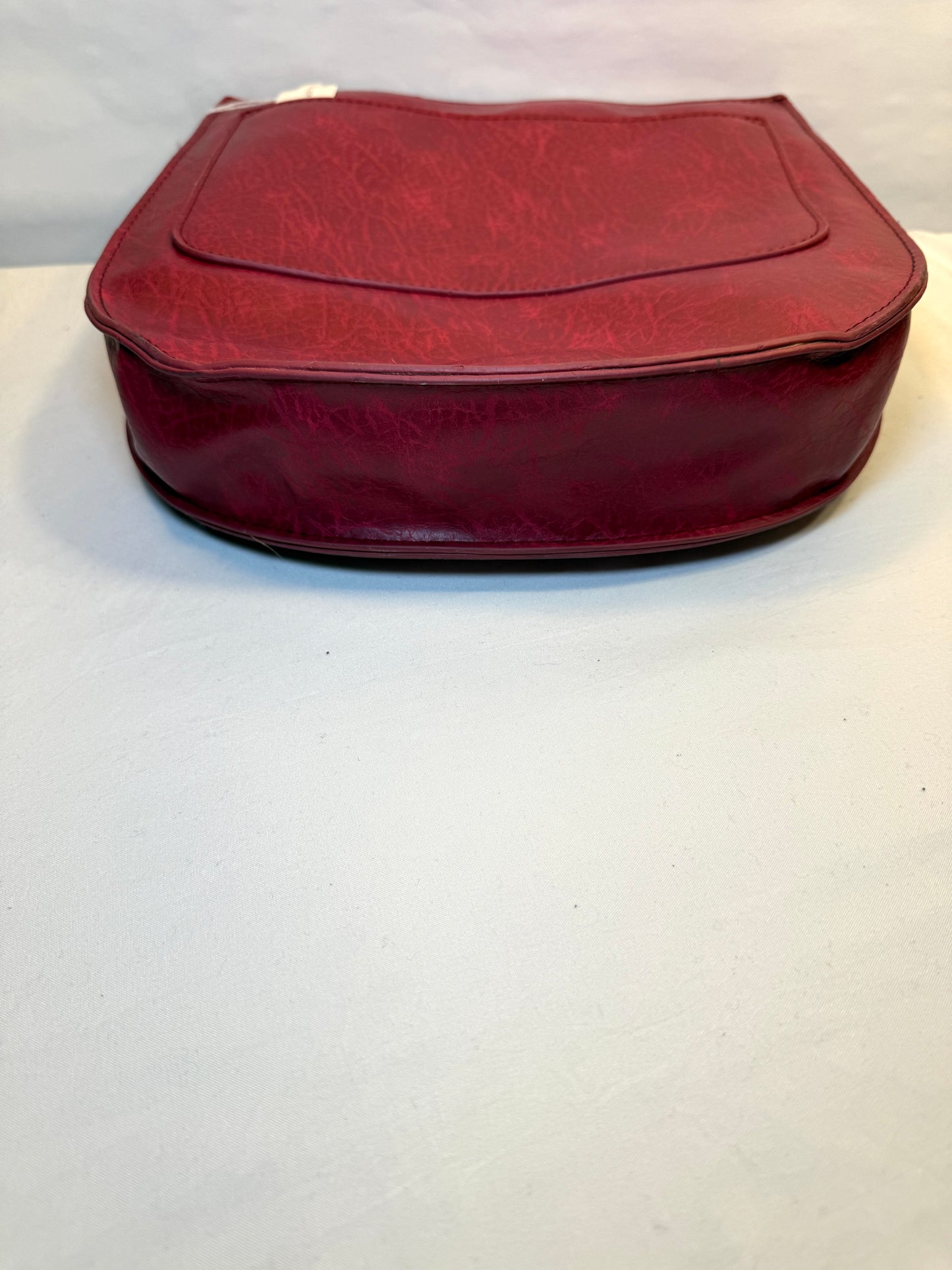 Crossbody Red Faux leather bag w/adjustable strap and side pocket.