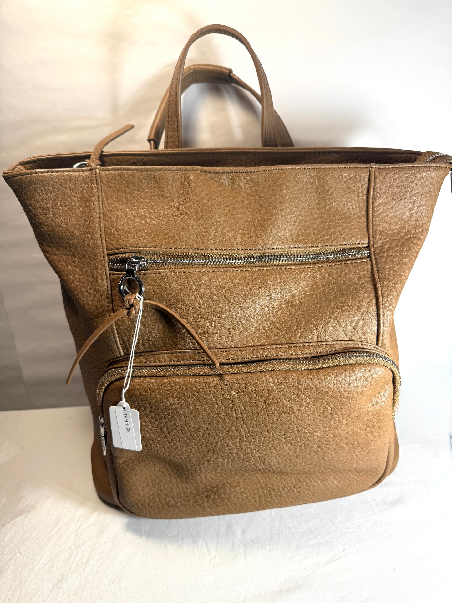 Vegan leather backpack w/functional strap that allows use as a backpack or a crossbody bag.  