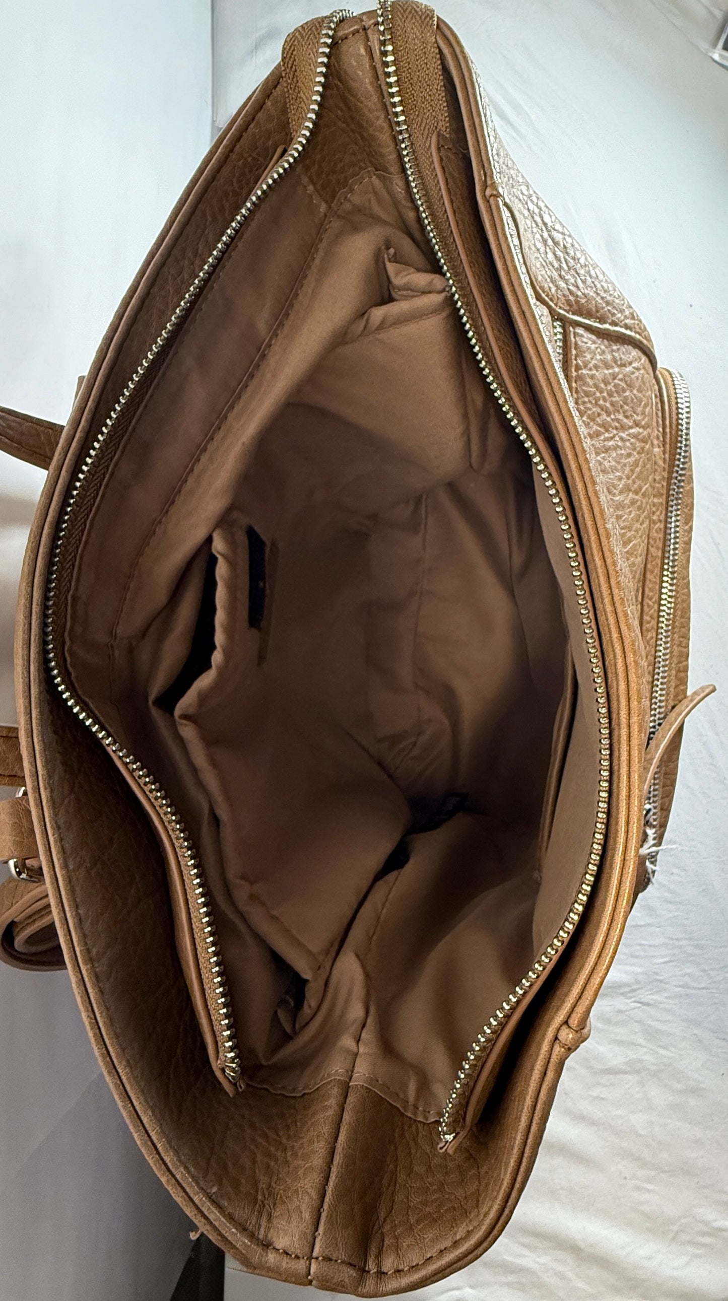 Vegan leather backpack w/functional strap that allows use as a backpack or a crossbody bag.  