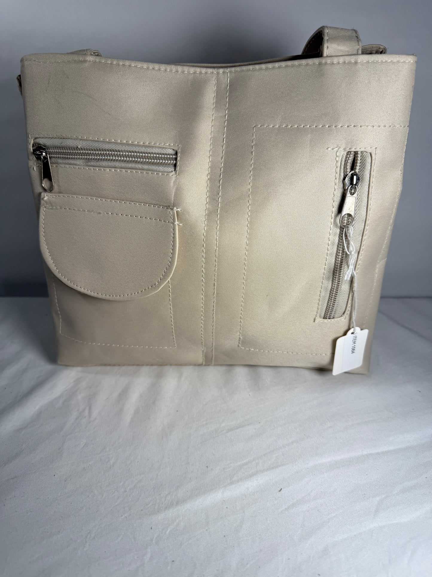 Pre-owned beige cargo style bag. 100% Polyester. Multi-Pocket Tote Bag